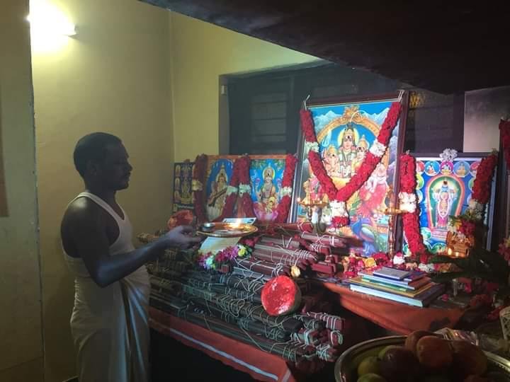 Guruji performing an evening puja before the shrine