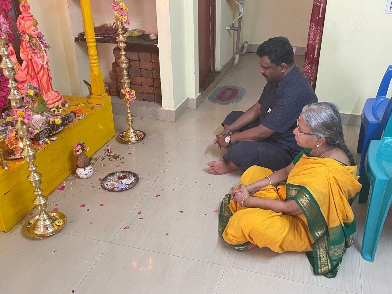 Guruji offering a blessing at a family shrine
