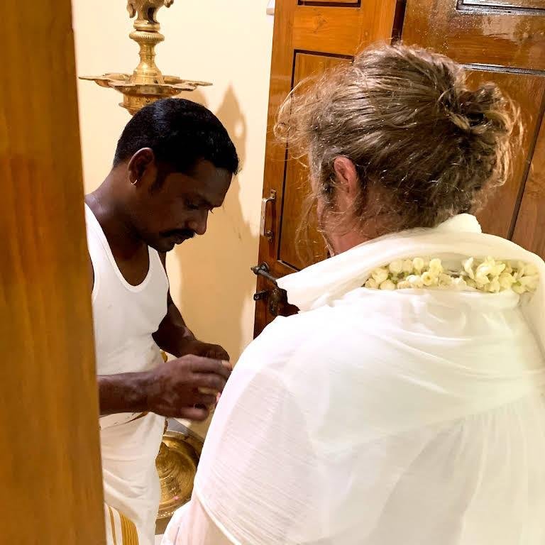 Guruji performing a traditional blessing for a seeker